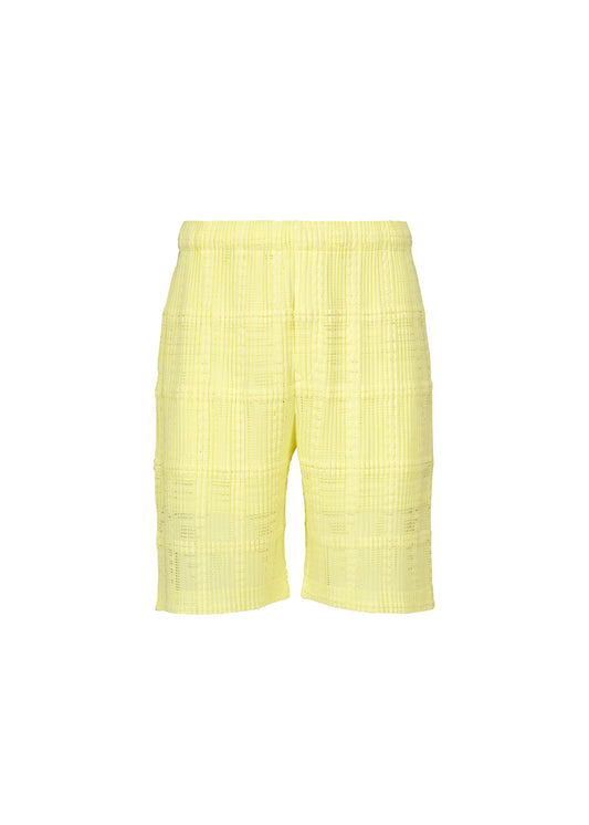 A product shot of the HOMME PLISSÉ ISSEY MIYAKE LACE GRID PLEATS shorts in yellow.