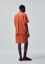 A model wears the HOMME PLISSÉ ISSEY MIYAKE MONTHLY COLORS : AUGUST monthly-colors-august-shirt-shine-yellow.