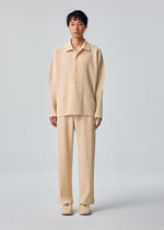 A model wears the HOMME PLISSÉ ISSEY MIYAKE MONTHLY COLORS : OCTOBER monthly-colors-october-long-sleeved-shirt-glow-cream.
