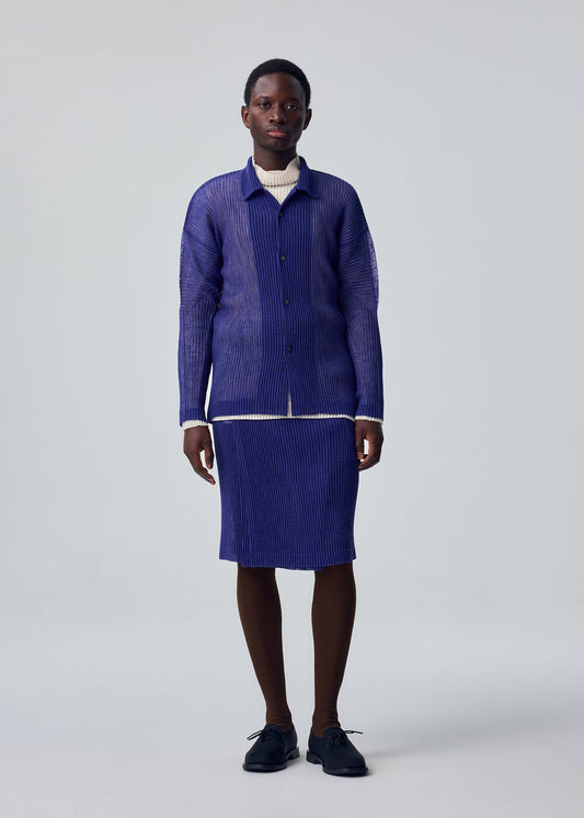 A model wears the HOMME PLISSÉ ISSEY MIYAKE RUSTIC MESH shirt.