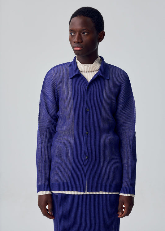 A model wears the HOMME PLISSÉ ISSEY MIYAKE RUSTIC MESH rustic-mesh-shirt-blue.