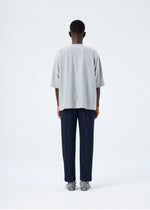 A model wears the HOMME PLISSÉ ISSEY MIYAKE RELEASE-T BASIC top.