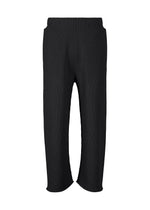 A product shot of the HOMME PLISSÉ ISSEY MIYAKE BASIC KNIT trousers in black.