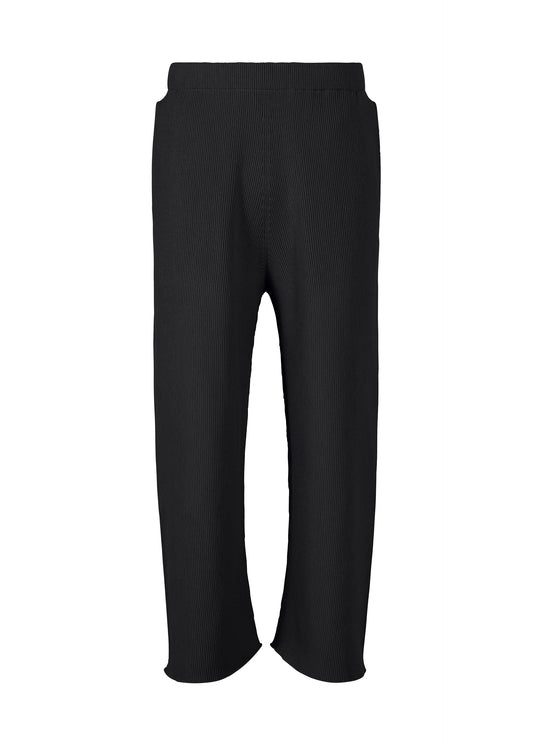 A product shot of the HOMME PLISSÉ ISSEY MIYAKE BASIC KNIT trousers in black.