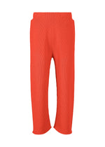 A product shot of the HOMME PLISSÉ ISSEY MIYAKE BASIC KNIT trousers in red.