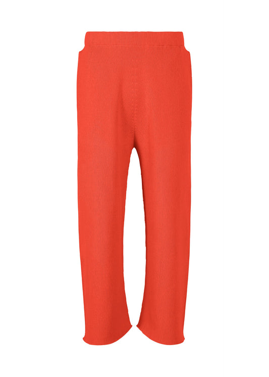 A product shot of the HOMME PLISSÉ ISSEY MIYAKE BASIC KNIT trousers in red.