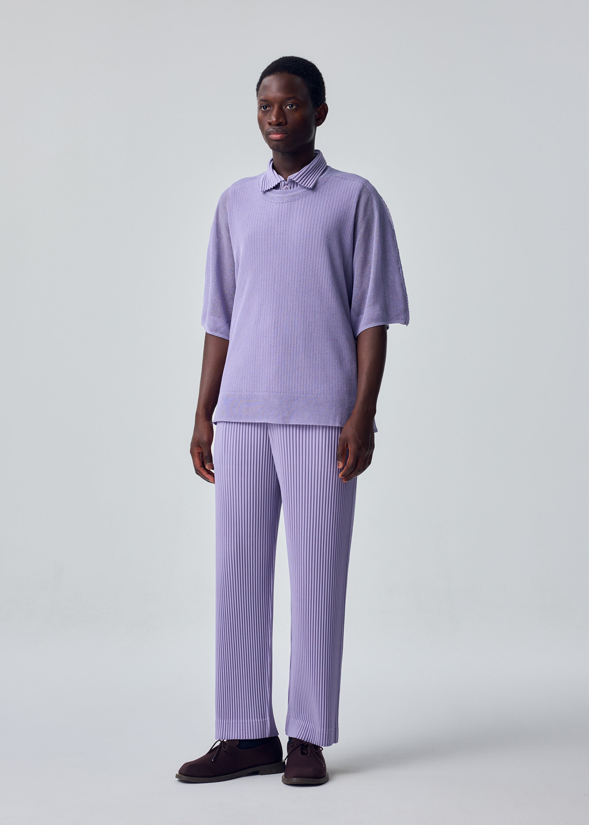 A model wears the HOMME PLISSÉ ISSEY MIYAKE WASHI FRAMEWORK-T top.
