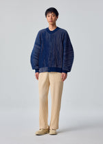 A model wears the HOMME PLISSÉ ISSEY MIYAKE IN THE SHADOW KNIT in-the-shadow-knit-cardigan-blue.