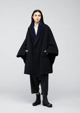 A model wears the 132 5. ISSEY MIYAKE ONE CLOTH COAT coat.