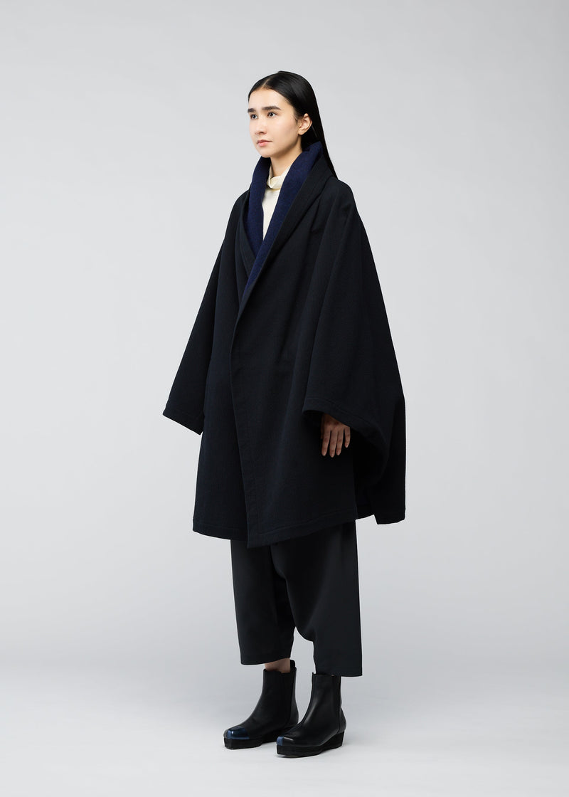 A model wears the 132 5. ISSEY MIYAKE ONE CLOTH COAT coat.