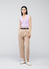 A model wears the 132 5. ISSEY MIYAKE  OBLIQUE FOLD BOTTOMS trousers