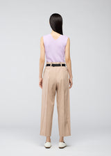 A model wears the 132 5. ISSEY MIYAKE  OBLIQUE FOLD BOTTOMS trousers