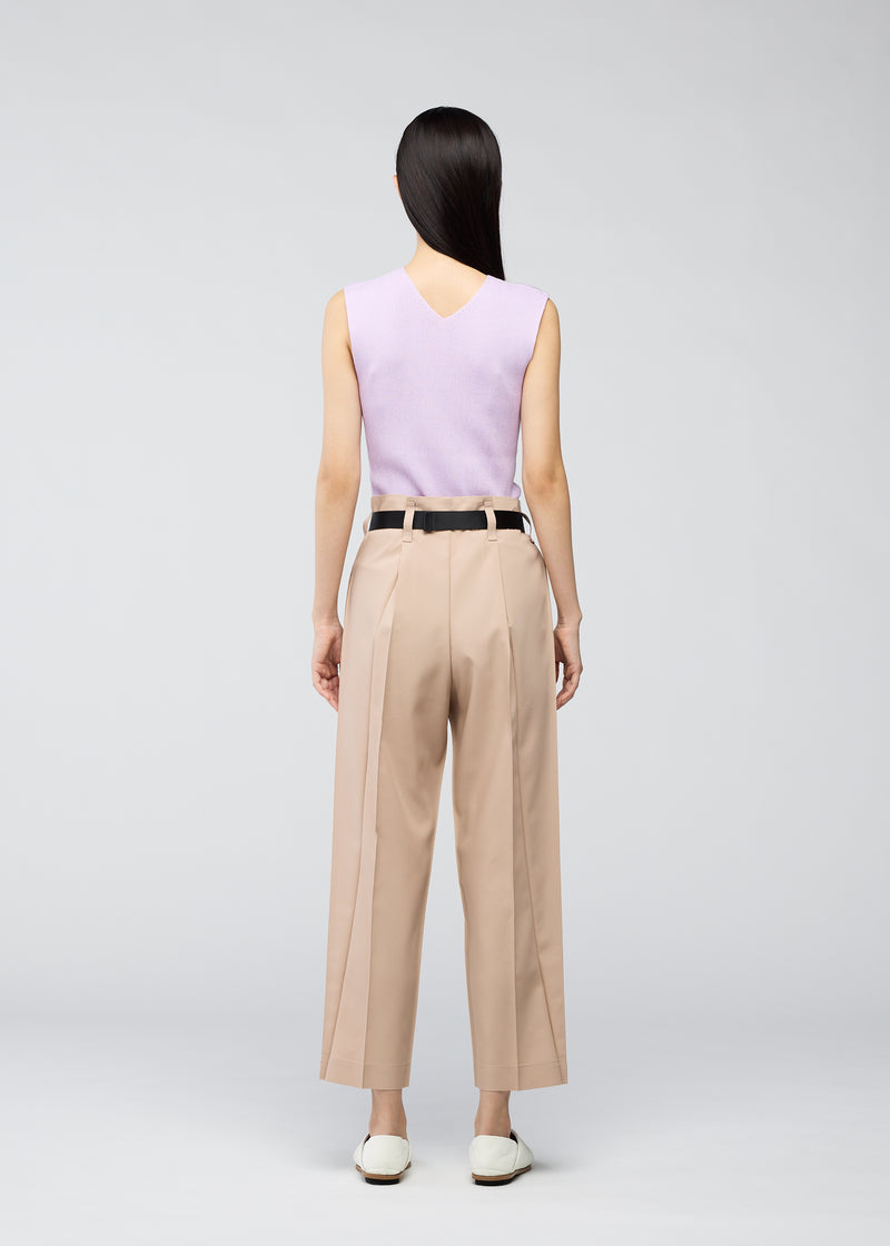 A model wears the 132 5. ISSEY MIYAKE  OBLIQUE FOLD BOTTOMS trousers