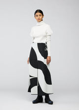 A model wears the 132 5. ISSEY MIYAKE CIRCULAR TILES trousers.