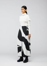 A model wears the 132 5. ISSEY MIYAKE CIRCULAR TILES trousers.