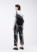A model wears the 132 5. ISSEY MIYAKE PARALLELEPIPED bag.
