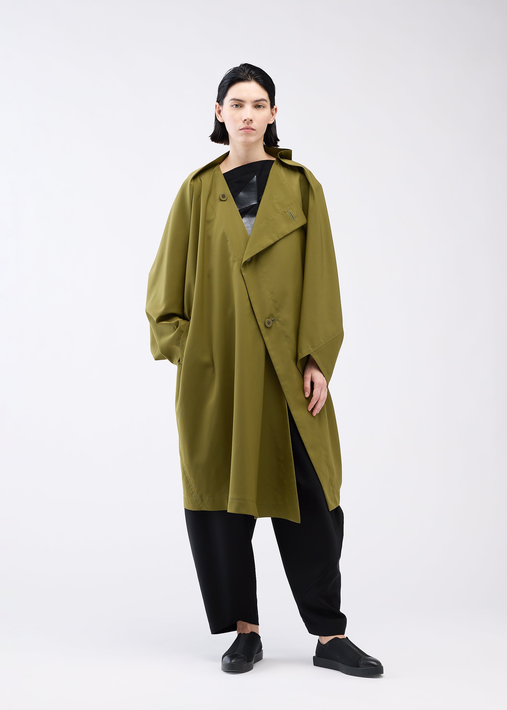 A model wears the 132 5. ISSEY MIYAKE PARALLEL WRAP coat.