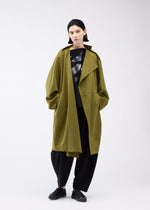 A model wears the 132 5. ISSEY MIYAKE PARALLEL WRAP coat.