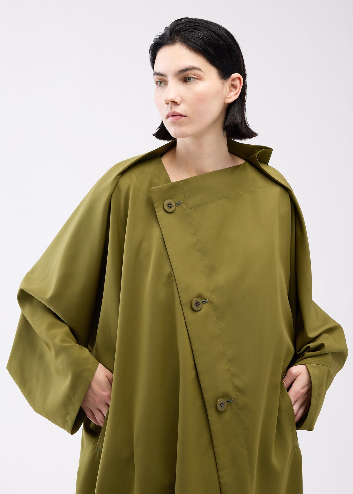 A model wears the 132 5. ISSEY MIYAKE PARALLEL WRAP coat.