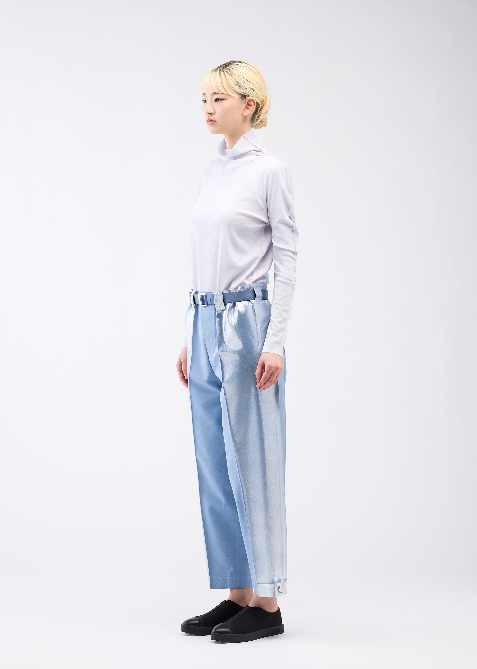 A model wears the 132 5. ISSEY MIYAKE TUCKED FOIL trousers.