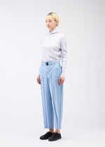 A model wears the 132 5. ISSEY MIYAKE EDGE BOTTOMS trousers.