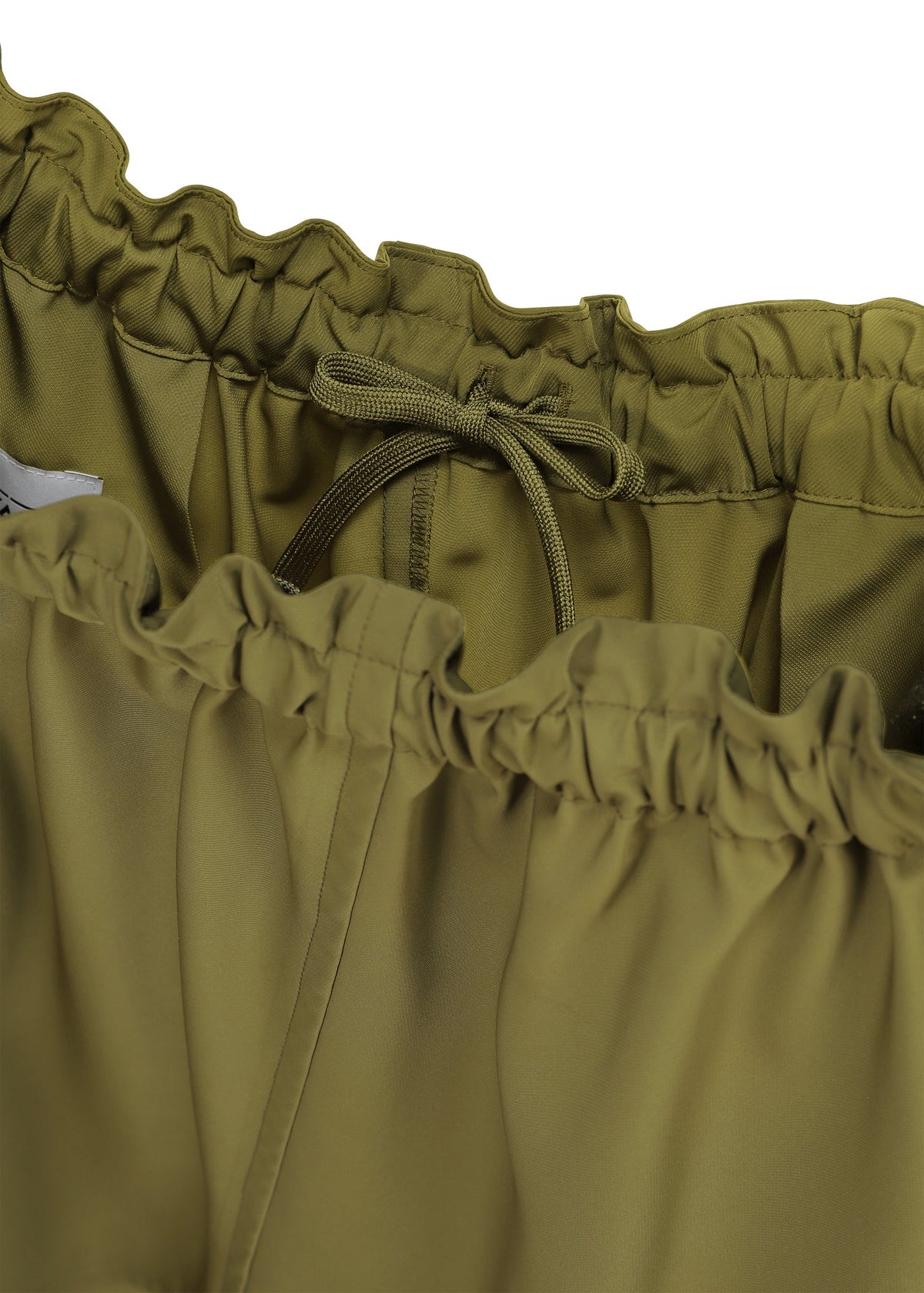 A detail shot of the 132 5. ISSEY MIYAKE PARALLEL WRAP trousers.