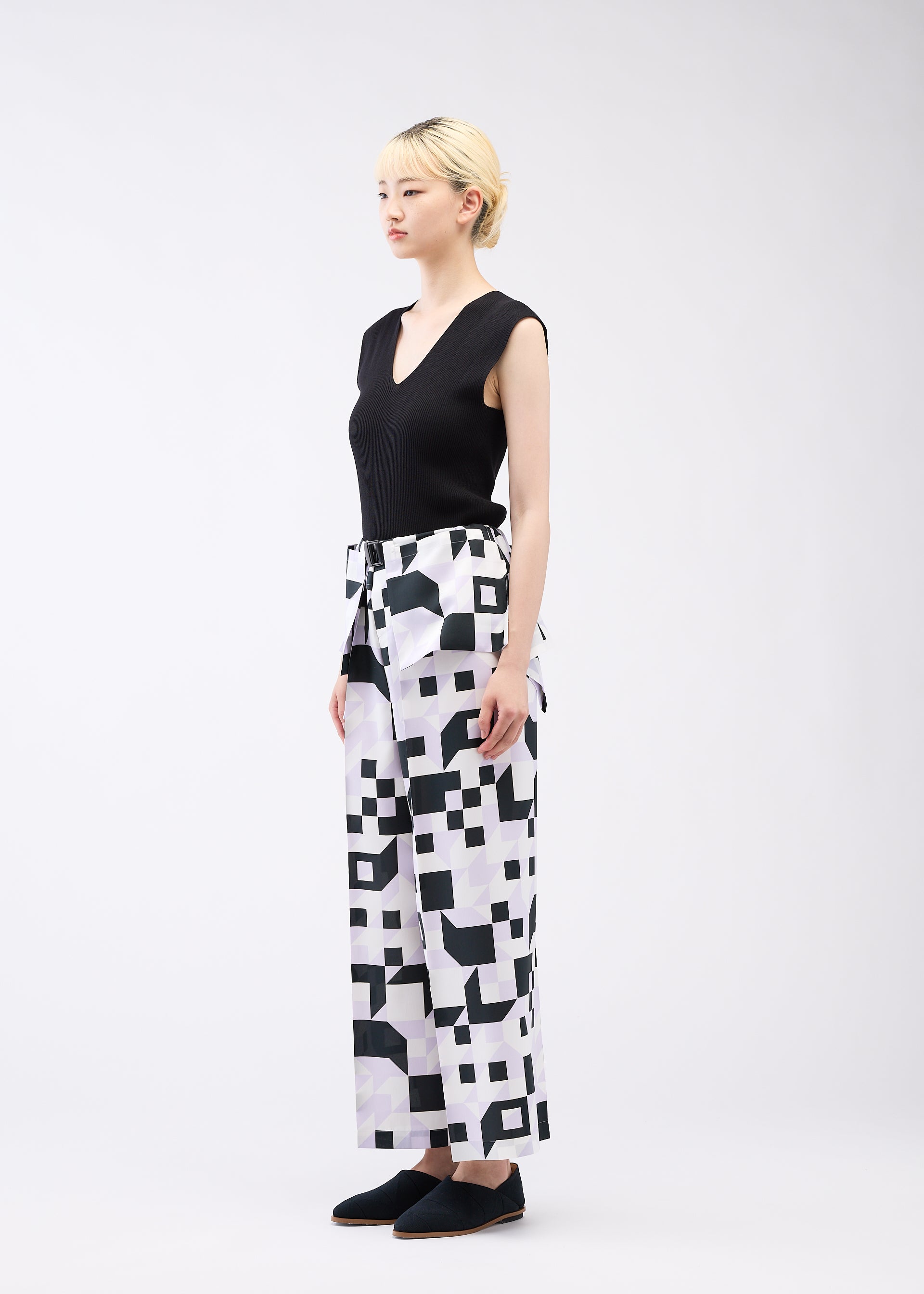 A model wears the 132 5. ISSEY MIYAKE BOX COMPOSITION trousers.