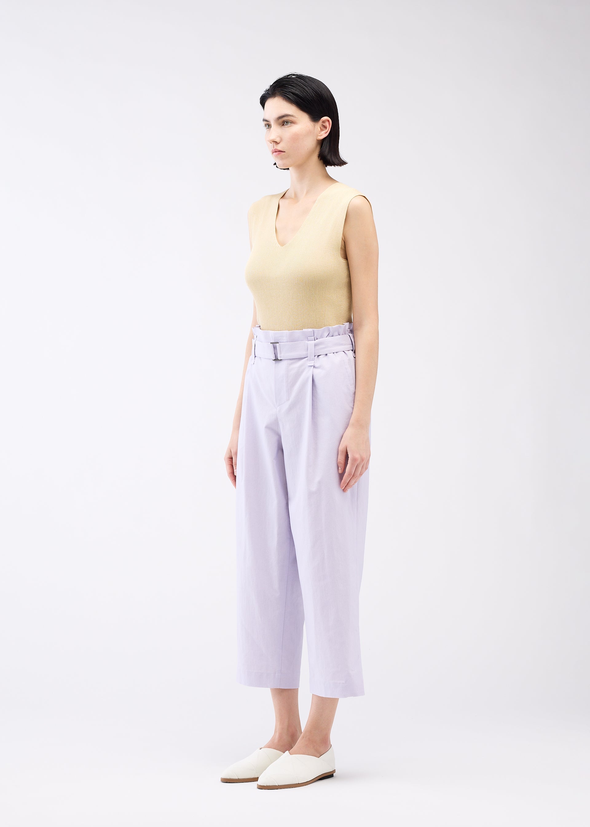 A model wears the 132 5. ISSEY MIYAKE WASHI STRETCH trousers.