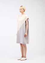 A model wears the 132 5. ISSEY MIYAKE FLAT T BI COLOR dress.