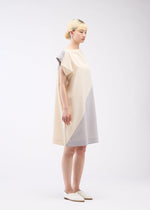A model wears the 132 5. ISSEY MIYAKE FLAT T BI COLOR dress.