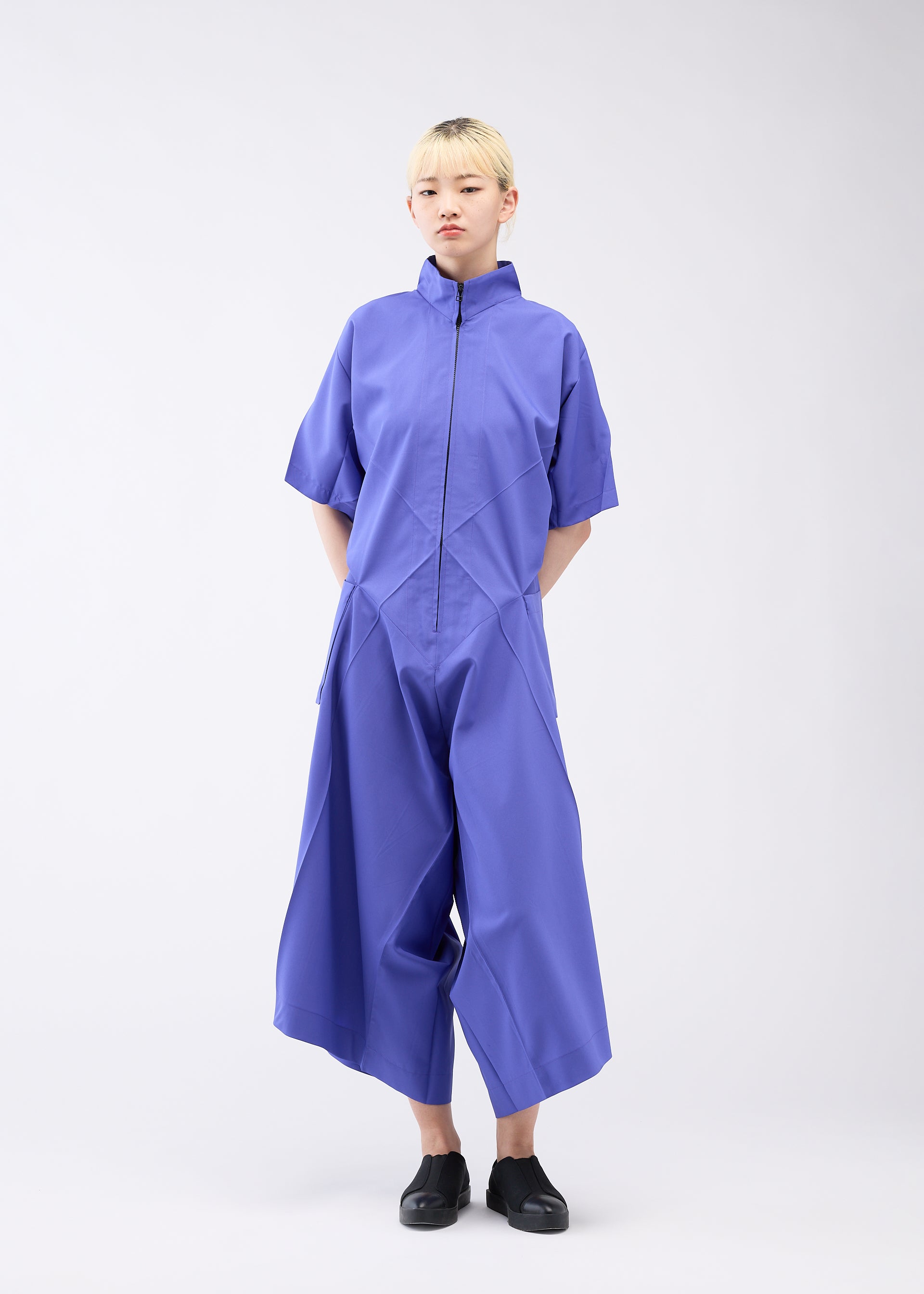 A model wears the 132 5. ISSEY MIYAKE UNIFIED HALF CUBES jumpsuit.
