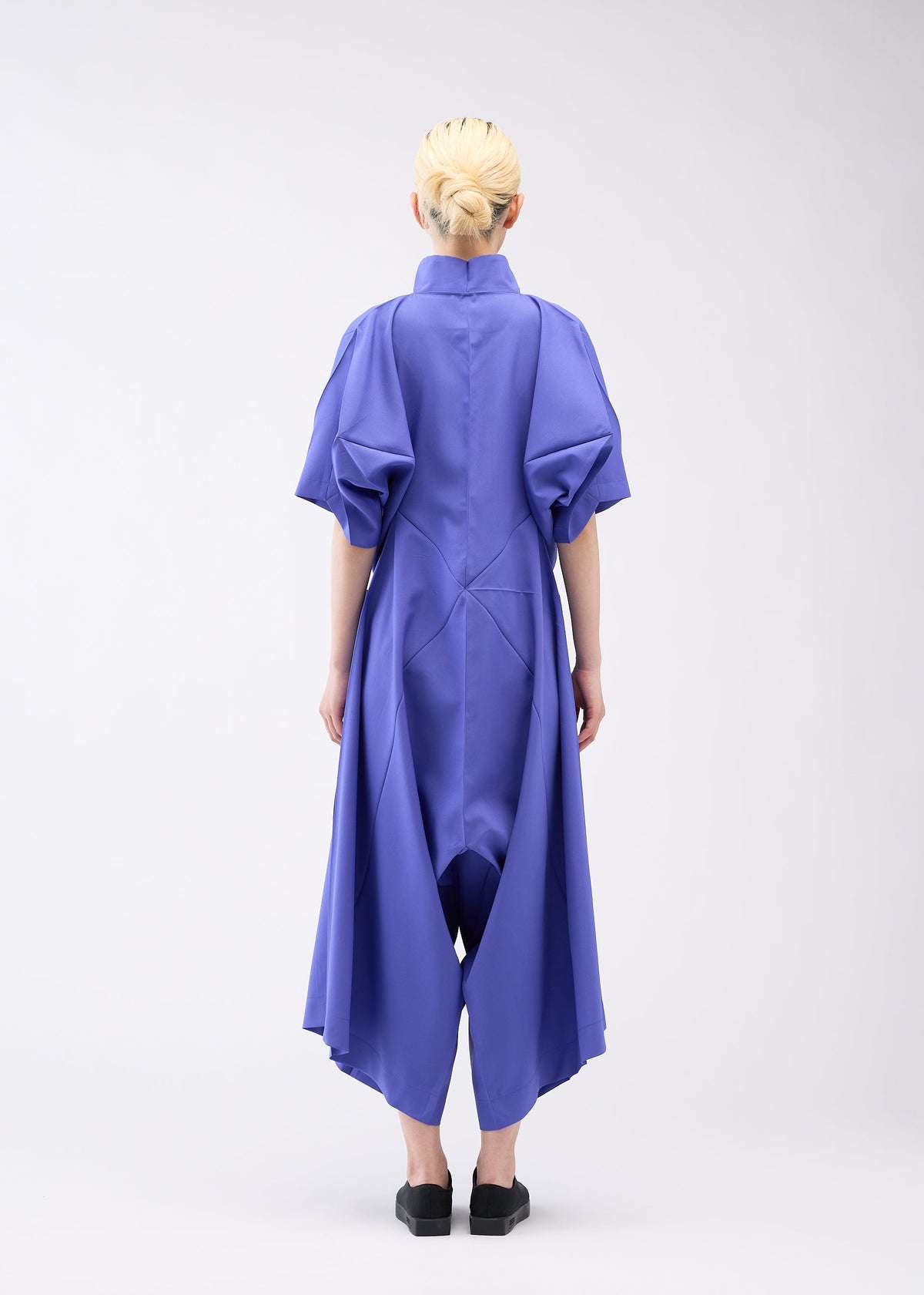 A model wears the 132 5. ISSEY MIYAKE UNIFIED HALF CUBES jumpsuit.