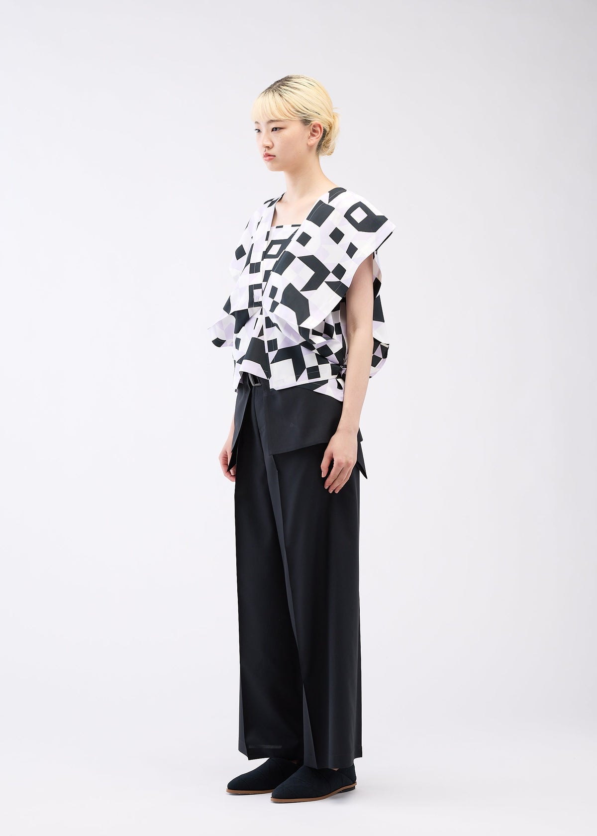 A model wears the 132 5. ISSEY MIYAKE BOX COMPOSITION shirt.