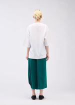 A model wears the 132 5. ISSEY MIYAKE FLAT ONE TUCK T shirt.