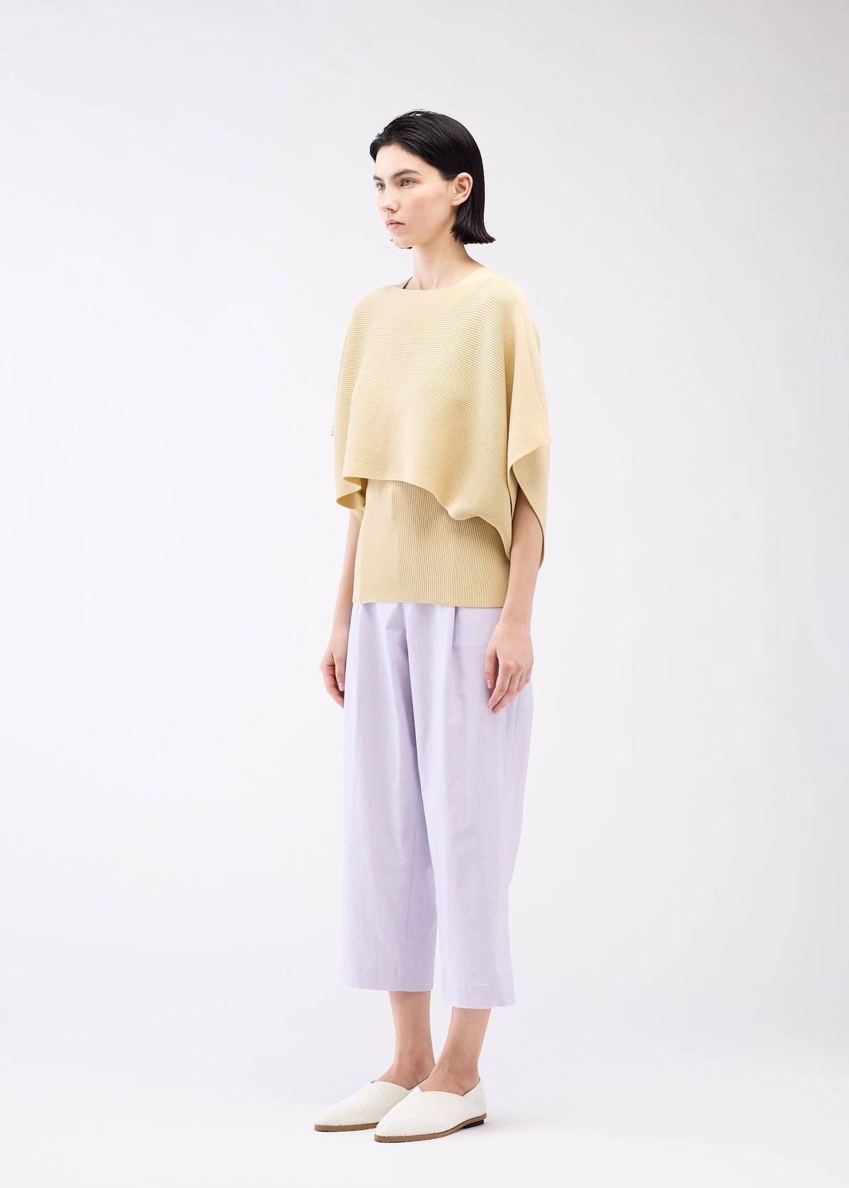 A model wears the 132 5. ISSEY MIYAKE FLAT RIB KNIT 2 top.