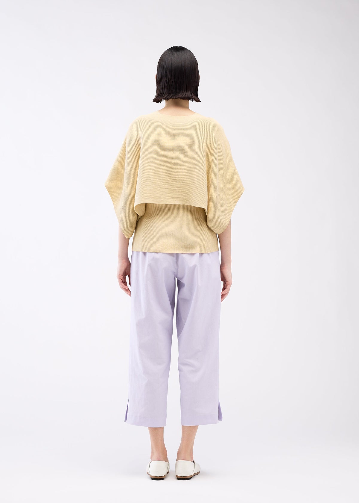 A model wears the 132 5. ISSEY MIYAKE FLAT RIB KNIT 2 top.