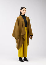 A model wears the 132 5. ISSEY MIYAKE DRAPE COAT coat.