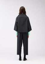 A model wears the 132 5. ISSEY MIYAKE 132 5. FLAT 1 jacket.