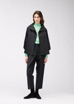 A model wears the 132 5. ISSEY MIYAKE 132 5. FLAT 1 jacket.