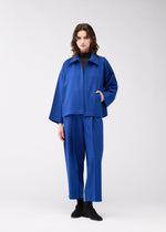 A model wears the 132 5. ISSEY MIYAKE WOOL LIKE FLAT TUCK jacket.