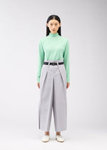 A model wears the 132 5. ISSEY MIYAKE FLAT SQUARE BOTTOMS trousers.