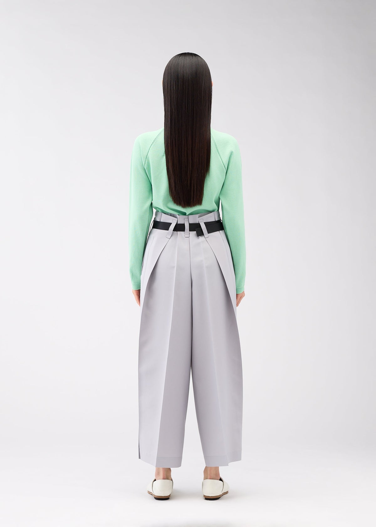 A model wears the 132 5. ISSEY MIYAKE FLAT SQUARE BOTTOMS trousers.