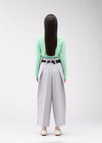 A model wears the 132 5. ISSEY MIYAKE FLAT SQUARE BOTTOMS trousers.