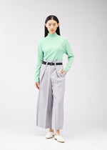 A model wears the 132 5. ISSEY MIYAKE FLAT SQUARE BOTTOMS trousers.