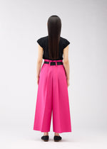 A model wears the 132 5. ISSEY MIYAKE FLAT SQUARE BOTTOMS trousers.