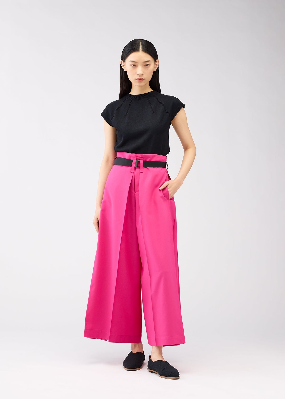 A model wears the 132 5. ISSEY MIYAKE FLAT SQUARE BOTTOMS trousers.