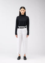 A model wears the 132 5. ISSEY MIYAKE 132 5. FLAT 1 trousers.
