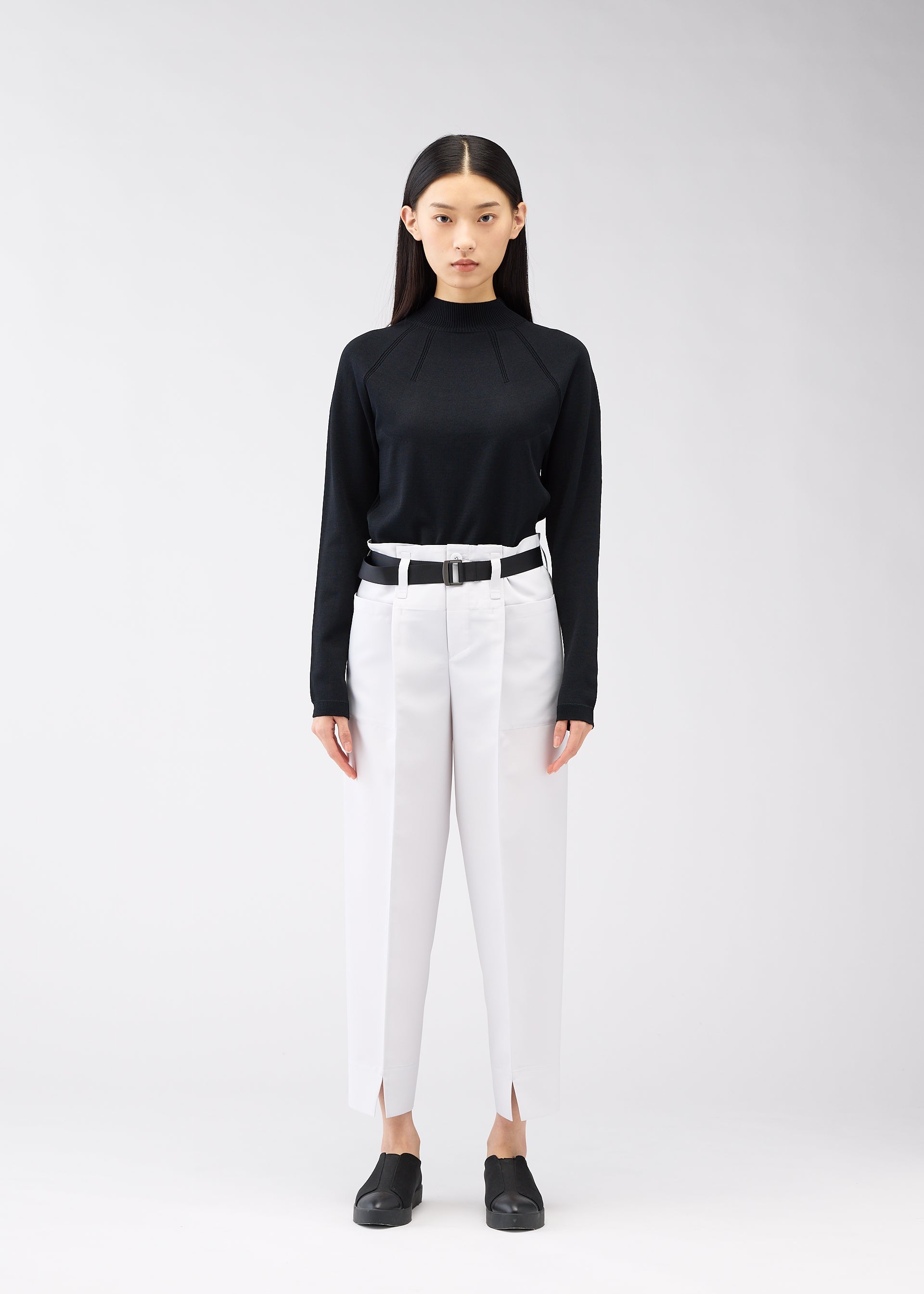A model wears the 132 5. ISSEY MIYAKE 132 5. FLAT 1 trousers.