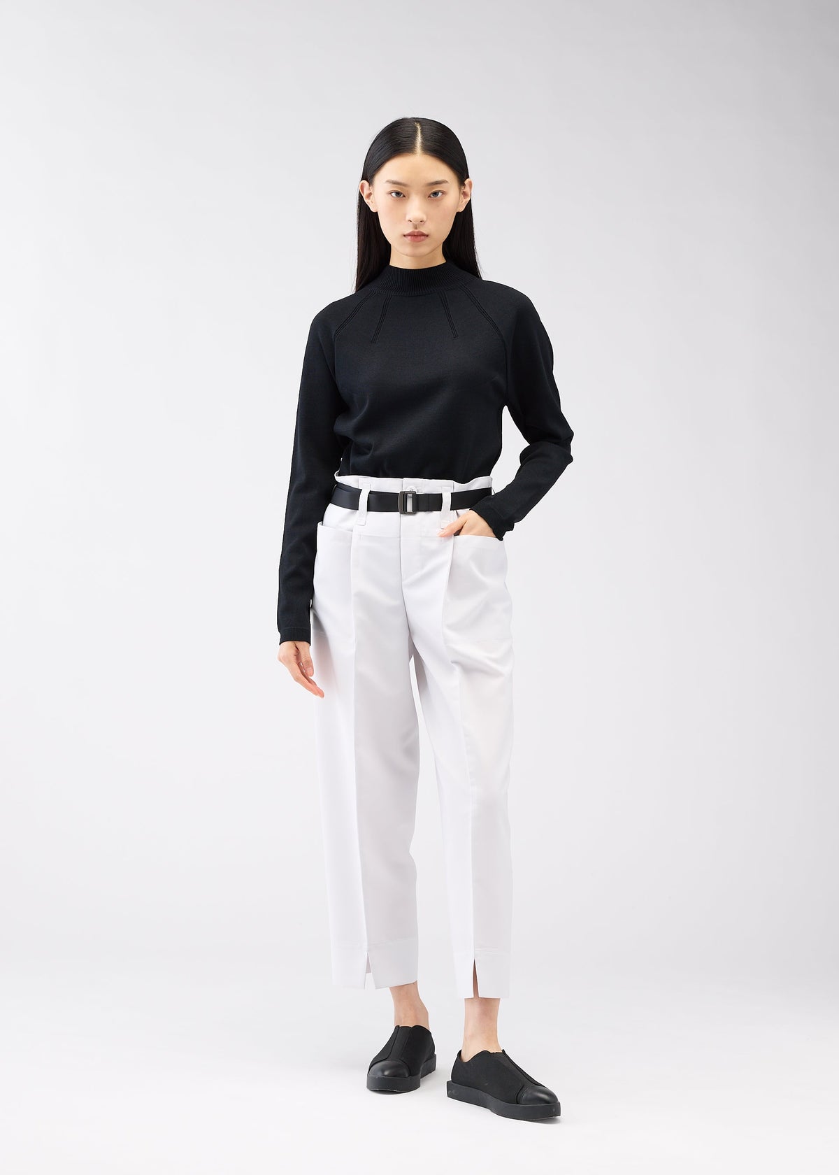A model wears the 132 5. ISSEY MIYAKE 132 5. FLAT 1 trousers.