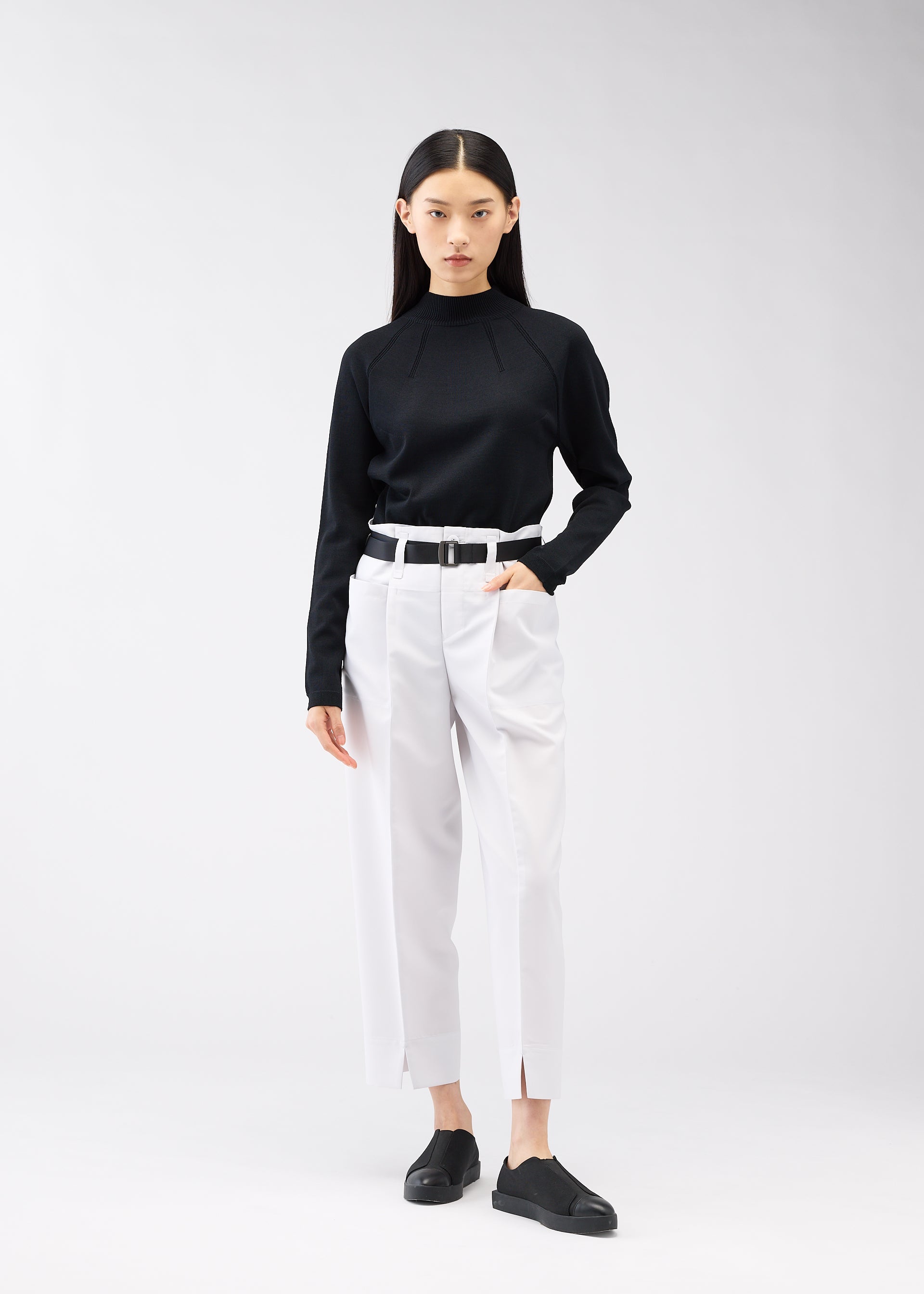 A model wears the 132 5. ISSEY MIYAKE 132 5. FLAT 1 trousers.
